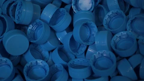 Piles of blue plastic caps lie in a box at a drinking water bottling plant Stock Footage 162759762