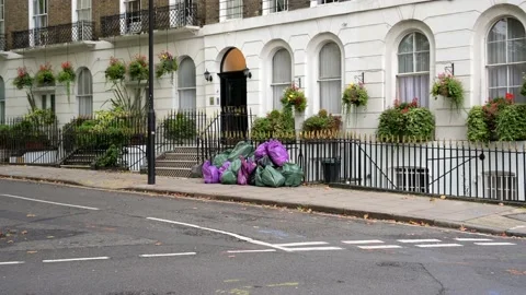 Piles of full bin bags outside London townhouses Stock Footage 170437059