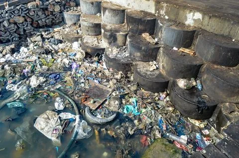 Piles of garbage floating on the seafront or waters Stock Photos