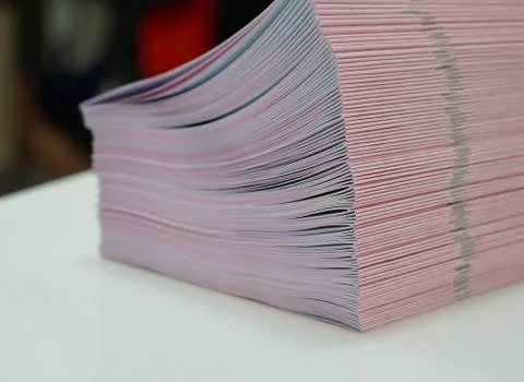 Piles of handout papers placed on table Stock Photos