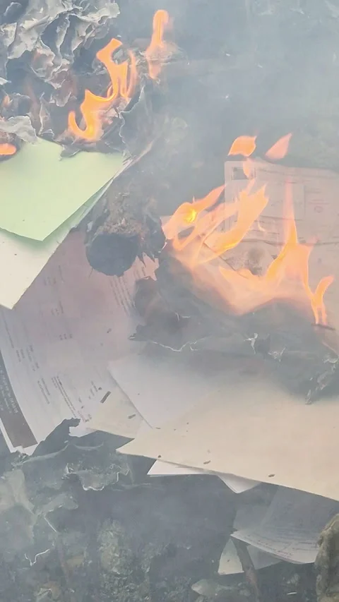 Piles of paper archives and documents burn outdoors in a controlled fire Vídeo Stock 321770254