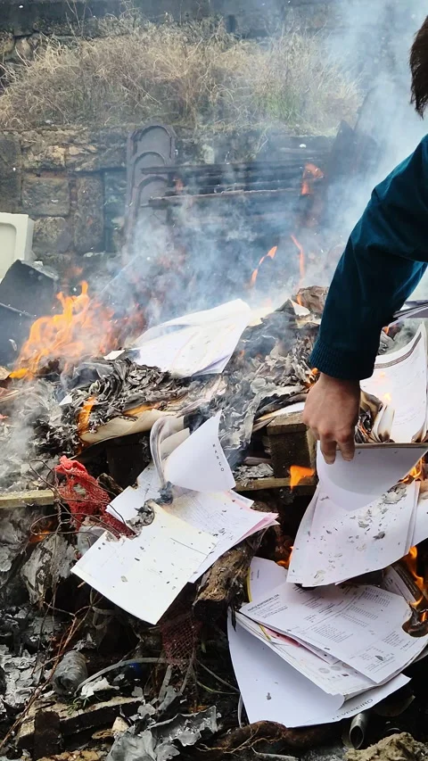 Piles of paper archives and documents burn outdoors in a controlled fire Vídeo Stock 321770329