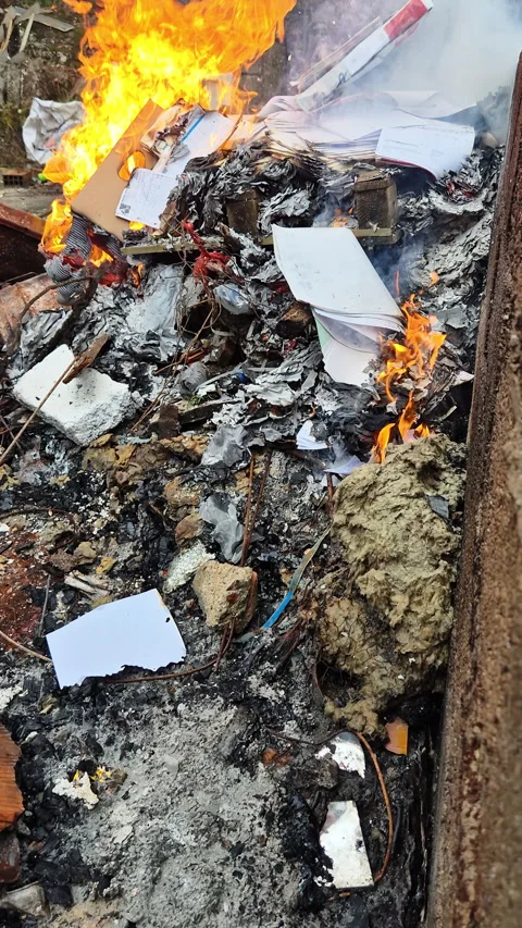 Piles of paper archives and documents burn outdoors in a controlled fire Vídeo Stock 321771696