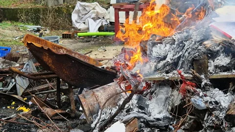 Piles of paper archives and documents burn outdoors in a controlled fire Vídeo Stock 321771923