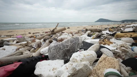 Piles of Plastic Garbage Pollute the Ocean Beach. A Lot of Plastic Debris Lies Stock Footage 317313070