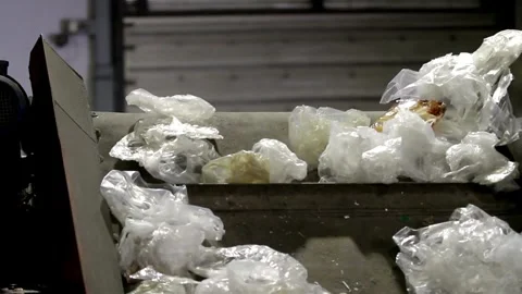 Piles of plastic packaging bottles for recycling at a waste processing plant are 動画素材 334661117