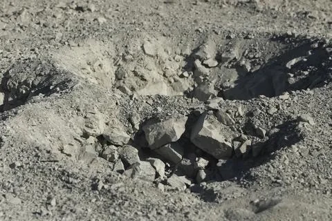 Piles of rock pulled out during the drilling of research pits in gold-beari.. Stock Photos