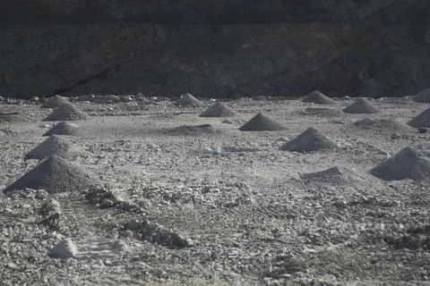 Piles of rock pulled out during the drilling of research pits in gold-beari.. Stock Photos