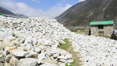 Piles of rocks and a developing building structure Stock Footage 77449878
