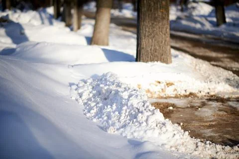 Piles of snow cleared from the sidewalks Foto stock