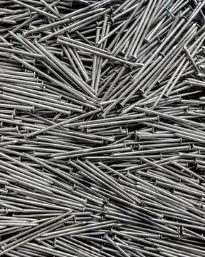 Piles of tiny metal nails which is used as a fastener, as a peg to hang somet Stock Photos