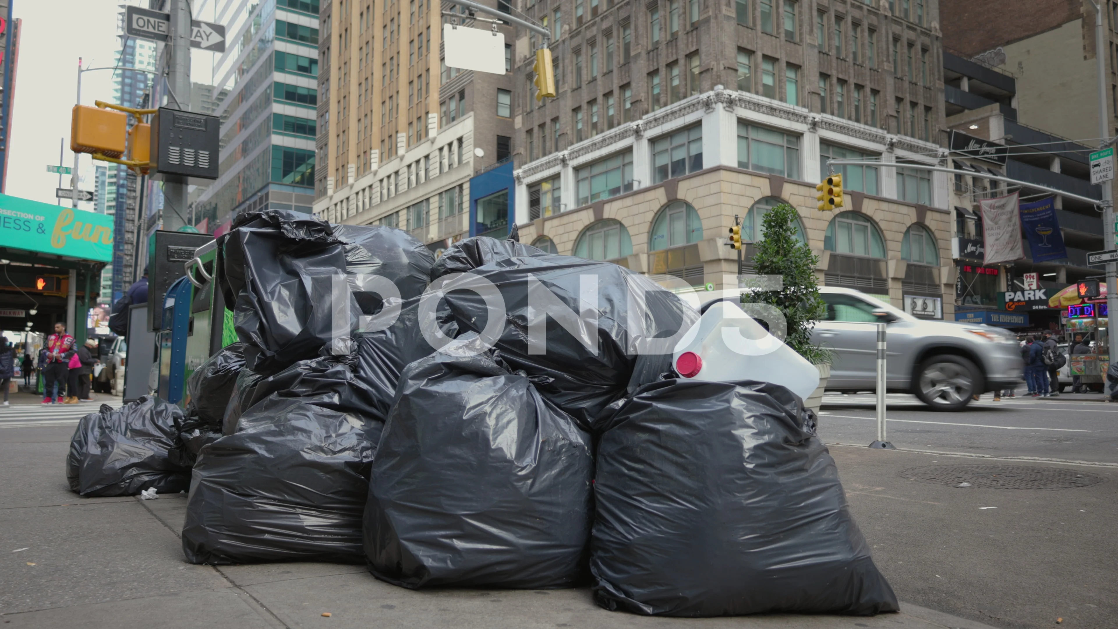 https://images.pond5.com/piles-trash-bags-city-sidewalk-footage-145380563_prevstill.jpeg