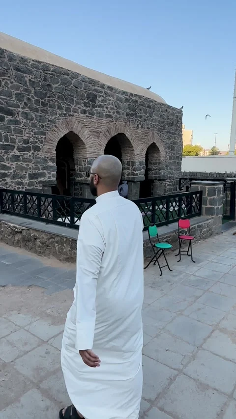 Pilgrim Walking Past Historic Stone Mosque in Medina Video stock 335328199
