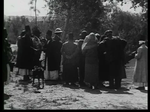 Pilgrims baptize themselves in the Jordan river Stock Footage 75306495