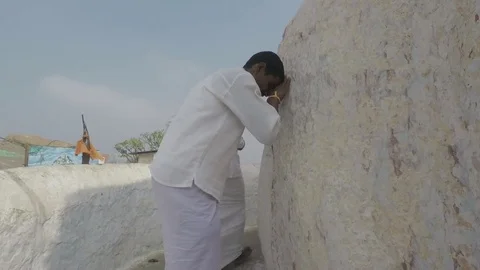 Pilgrims bow in prayer outside Hindu god Hanuman's birthplace temple, Stock Footage 83469302