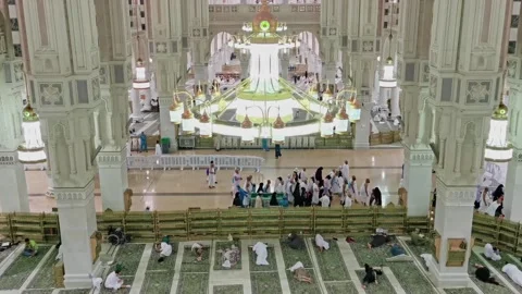 Pilgrims in 'ihram' clothes rest inside Al Haram Mosque in Makkah, Stock Footage 274472383