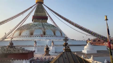Pilgrims making kora around the Boudhanath Stupa in an early morning 動画素材 233484367