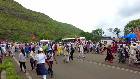 Pilgrims or Warkari with saffron flags participate in Pandarpur Wari Stock Footage 281186949