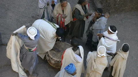 Pilgrims singing and dancing in front of the church of St. George in Lalibela Stock Footage 64963400
