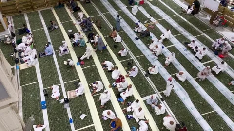 Pilgrims sitting inside Masjid al-Haram Makkah Stock Footage 332589030