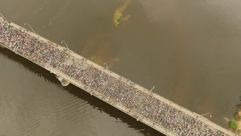 Pilgrims of the Velikoretsky procession walk in column across the bridge ove Stock Footage 275588271