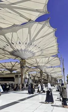 Pilgrims walk to the main mosque of the Prophet Muhammad Al-Masjid an-Nabawi Stock Photos