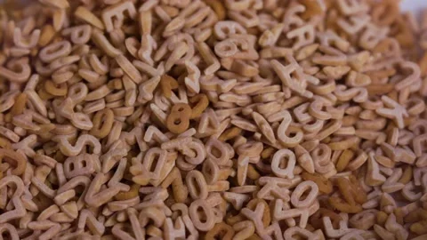 Piling alphabet soup falling on a heap, Slow Motion 1000fps Stock Footage 149154998
