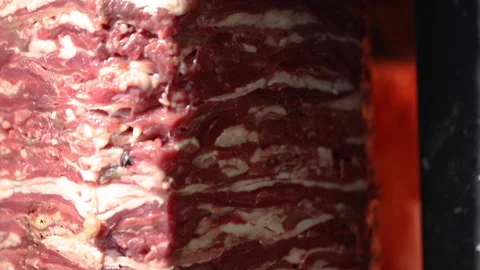 Piling up and preparing doner at a traditional restaurant, uncooked meat Stock Footage 145650886