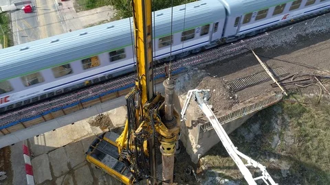Piling close-up, passing train in the background, aerial view Stock Footage 120394576