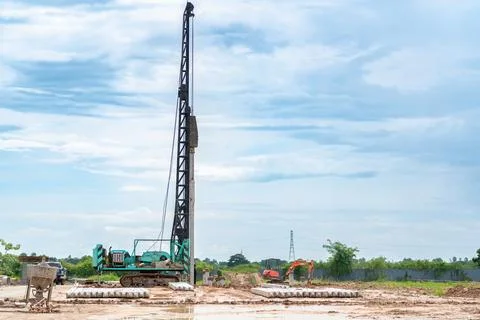 Piling machine and mini excavator working on foundation ground preparation .. Stock-Fotos