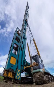 Piling machine at a construction site, shot with distortion by a short throw  Stock Photos