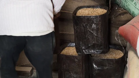 Piling up old metal containers full of rice in storage room, rice mill 库存影片 112254565