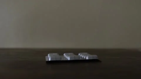 Piling pills on a table Stockbeeldmateriaal 238024851