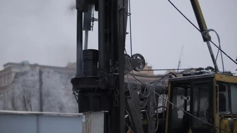 Piling rig drilling foundation pile in winter conditions Stock Footage 327041664