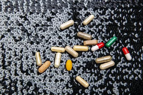Pill on black sequin Stock Photos