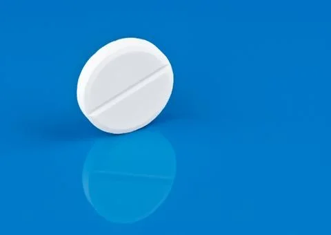 Pill on blue background Stock Photos