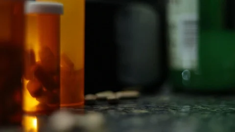 PILL BOTTLE DROPS INTO FRAME Stock Footage 113322906