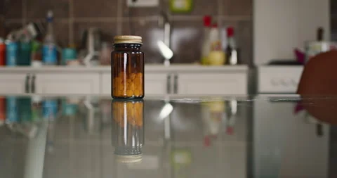 Pill Bottle On The Glass Table Stock Footage 237693187