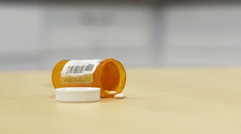 Pill Bottle Tipped Over on Kitchen Table Video stock 58483244