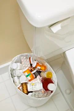 Pill Bottles in Garbage Can Stock Photos