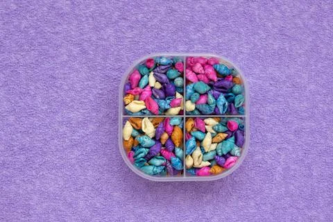 A pill box with colored shells instead of pills. View from above. The concept of Stock Photos