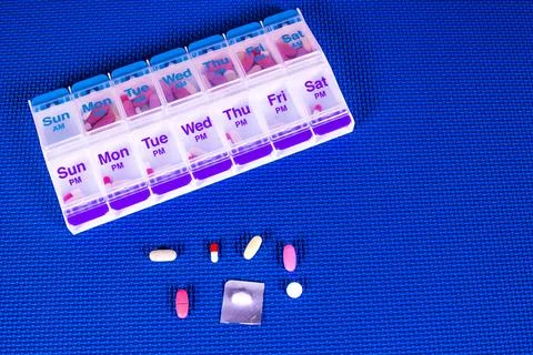 Pill Box Container On Blue Pattern Background Stock Photos