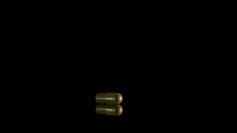 Pill capsule falling on the mirror table. Slowmotion shot, 180 fps Stock-Footage 86283769