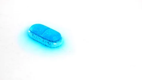 Pill capsule, Timelapse Macro shot Dissolves In Water. White background close up Stock Footage 72232090