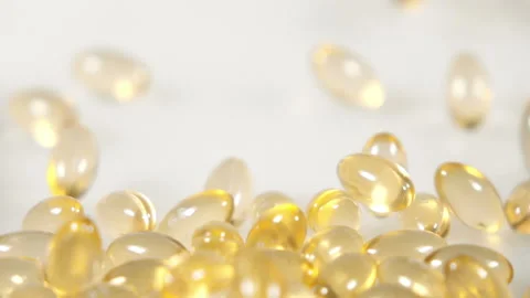 Pill capsules falling on white background, slow motion Video stock 236736371