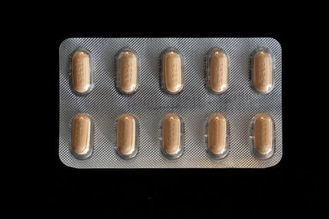A pill container with a black background Stock Photos