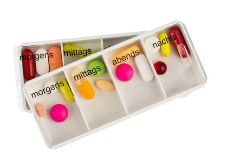 The pill dispenser and tablets Stock Photos