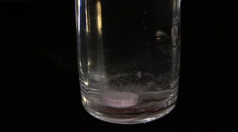 Pill  dissolves in water Stock Footage 10825318