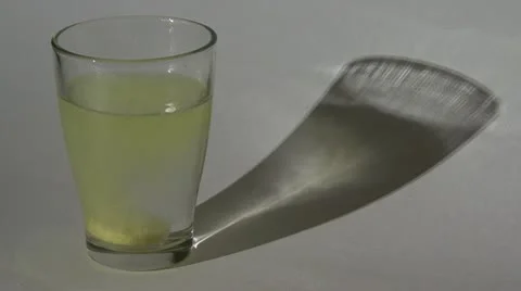 Pill dissolves in water. glass  shade Stock Footage 10825739