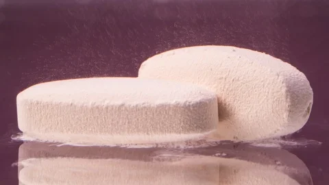 Pill dissolving in water on purple background. Stock Footage 119088326